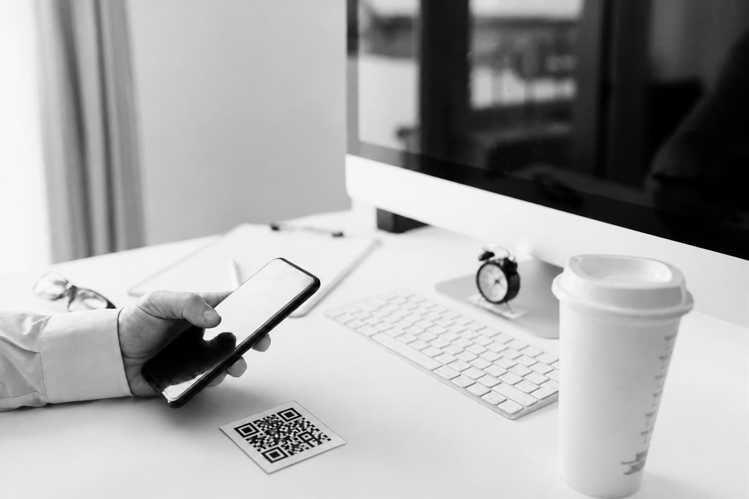 A person using a smartphone at a desk